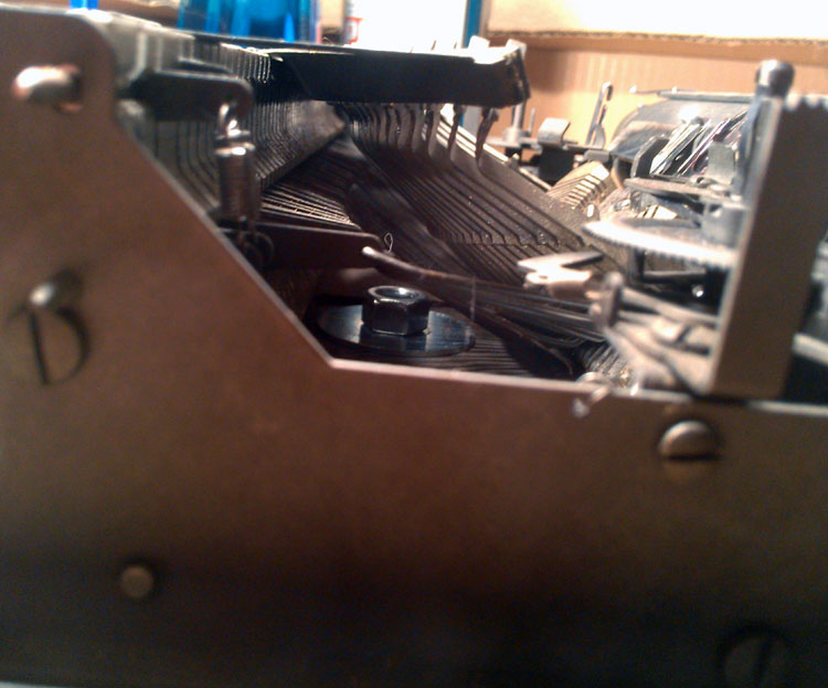 Positioned so the nut protruding into the body doesn't interfere with the typewriter's workings...