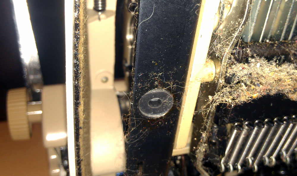 the rubber bushing remains in the frame. you can poke it through from underneath.