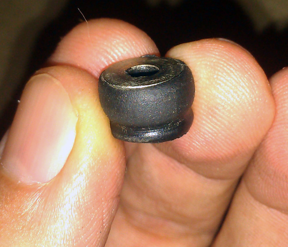 The original, permanently squished rubber bushing.